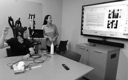 A participant completes a task while fNIRS records activity